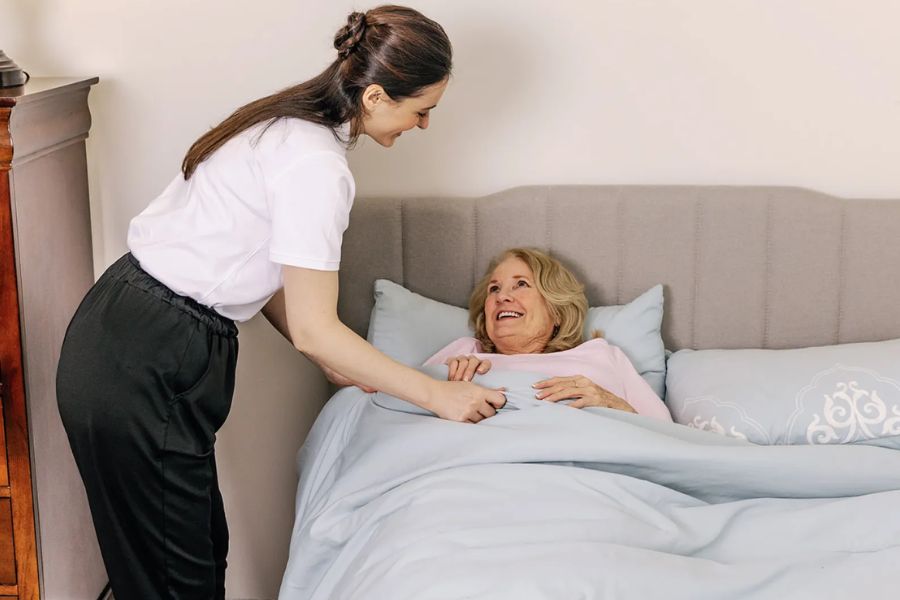 Overnight Caregiver putting senior to bed