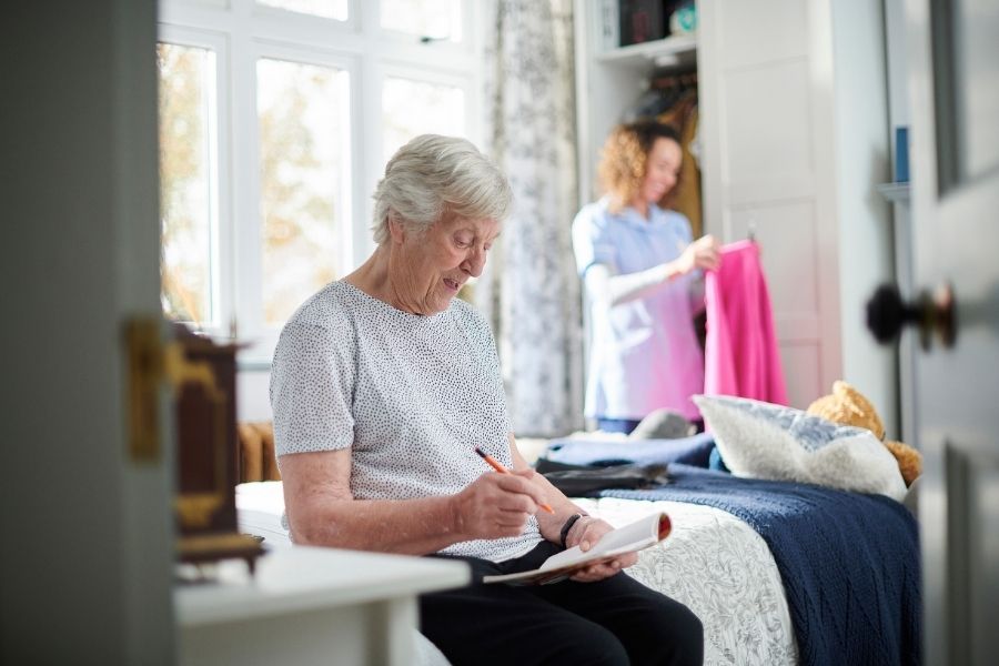 caregiver doing laundry as a part of elderly home care