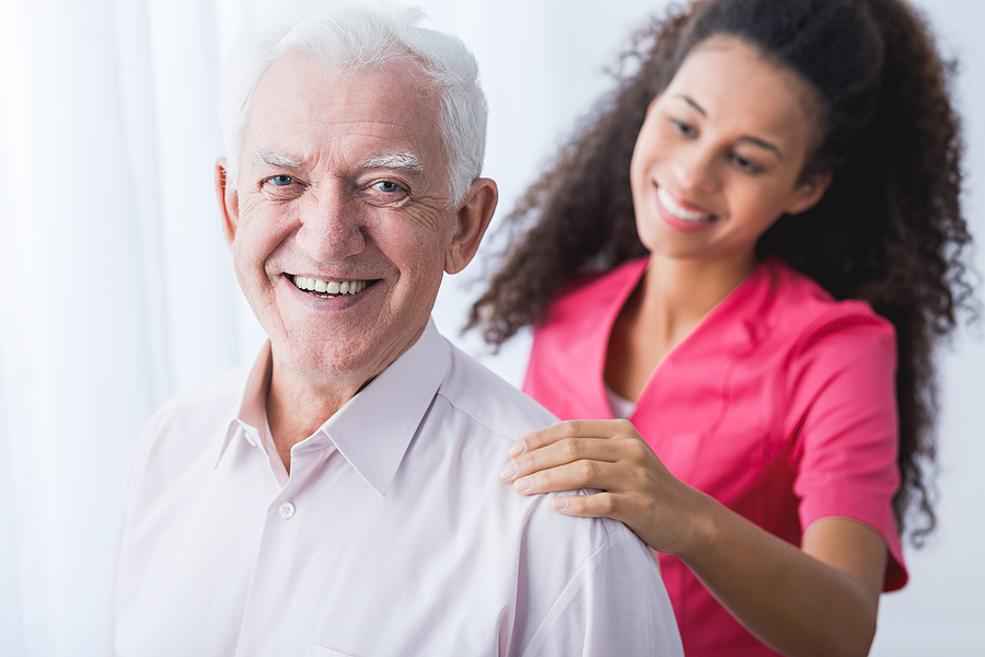Smiling senior man with a caregiver matched to his needs for in-home care in Cornelius, NC