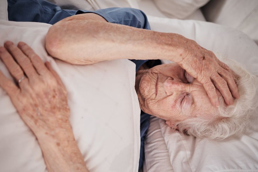 senior woman who has parkinsons is having sleeping issues at night