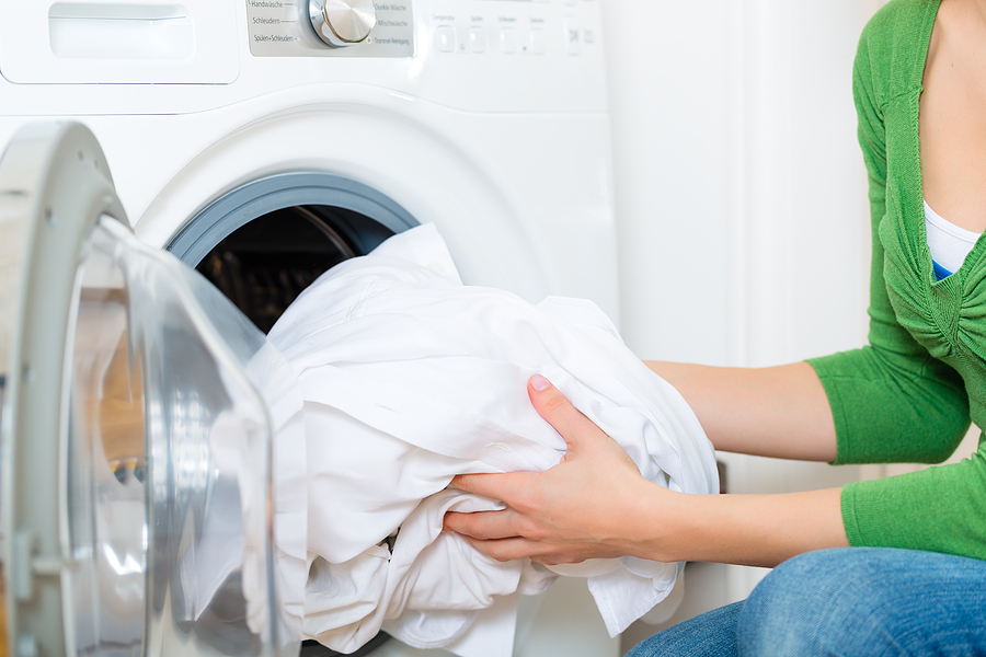 white laundry going into washer