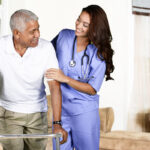 A Place At Home Health care worker helping an elderly man