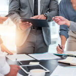 People standing around a desk working