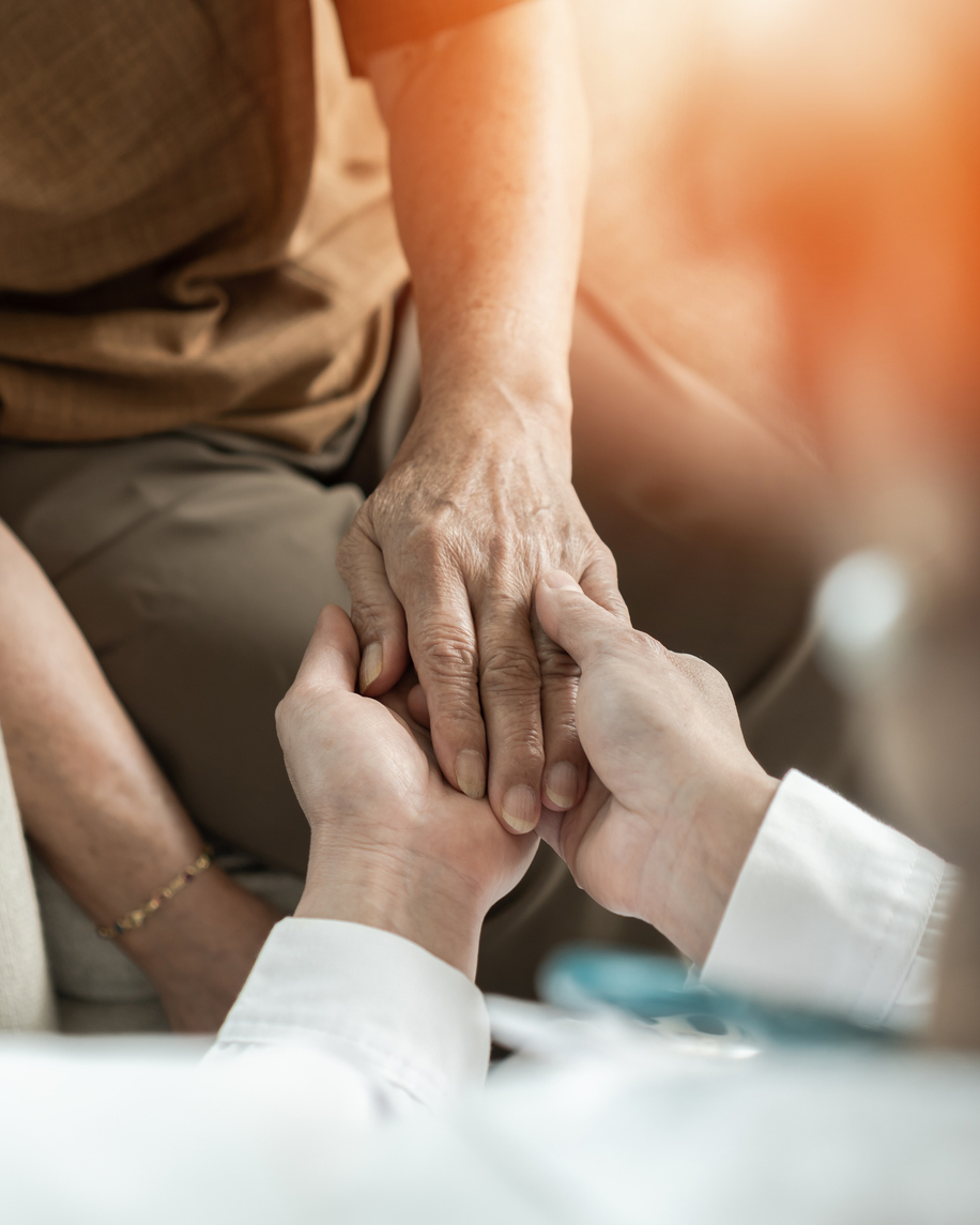 close up of patient and care taker holding hands