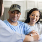 A retired soldier and his wife discuss money planning with a professional advisor