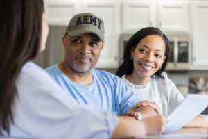 A retired soldier and his wife discuss money planning with a professional advisor