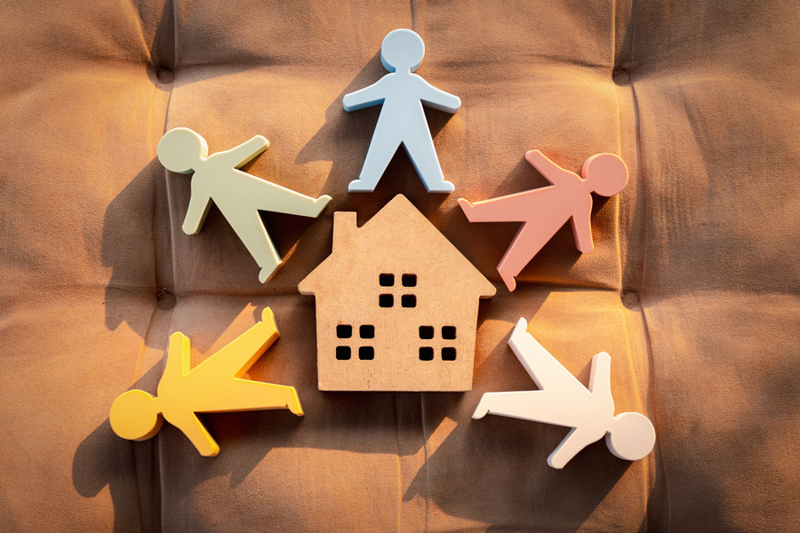 Illustration of a home surrounded by people, symbolizing family support and in-home care services
