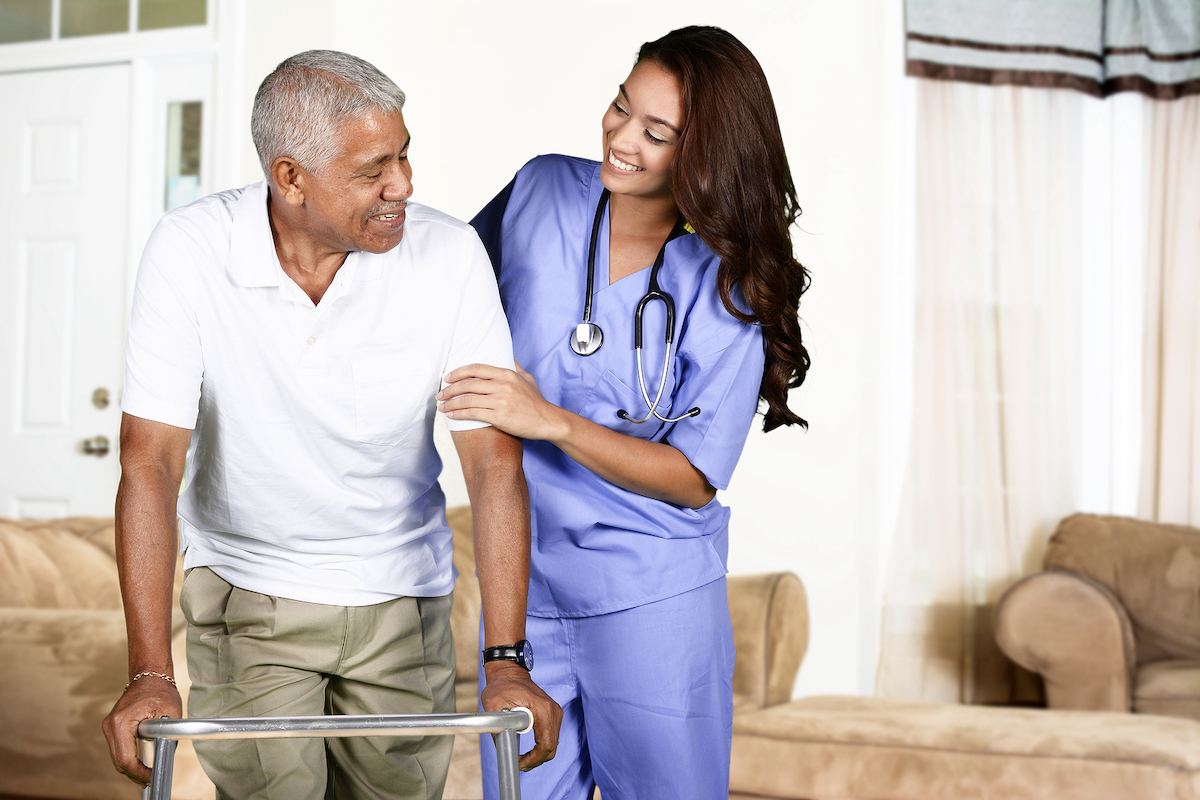 A Place At Home Health care worker helping an elderly man