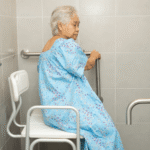 senior sitting in bathroom