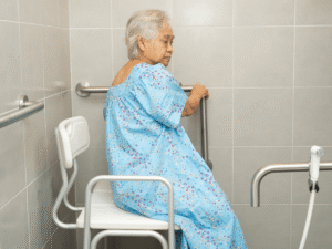 senior sitting in bathroom