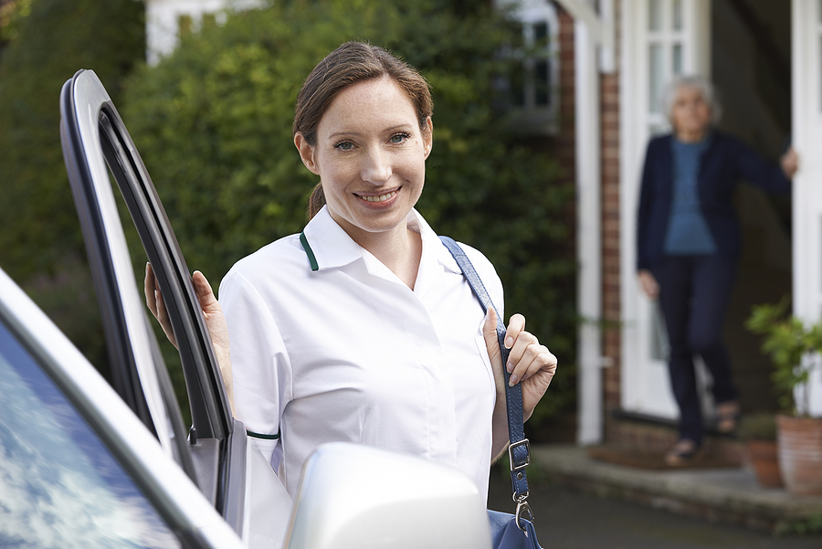 Smiling caregiver getting out of vehicle