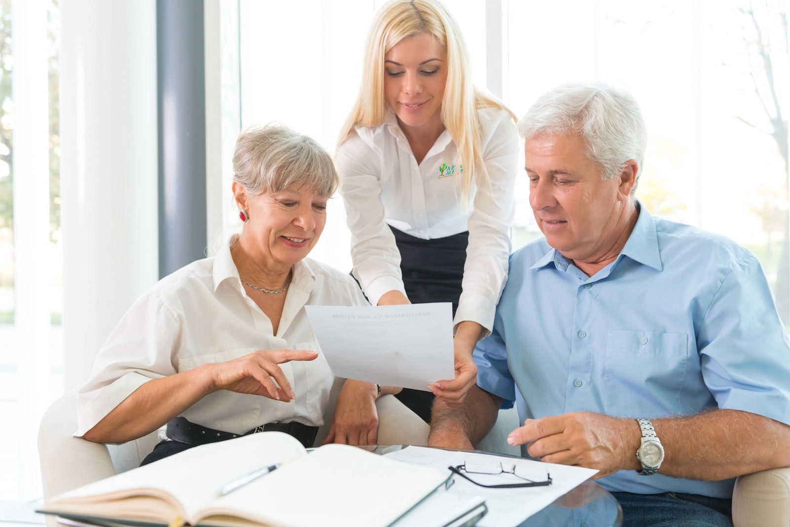 Elderly couple going over paperwork with caregiver