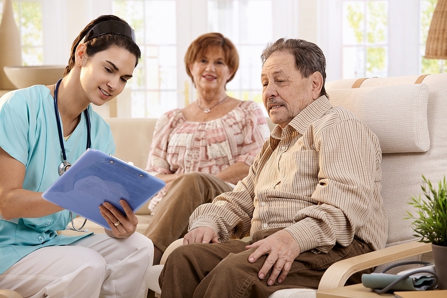 A place at home caregiver going over notes with elderly man