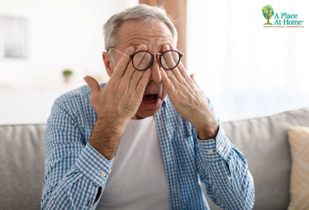 senior sitting on sofa and check eye