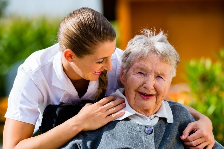 Caregiver giving companionship and warmth to a senior woman in Los Alamitos, CA
