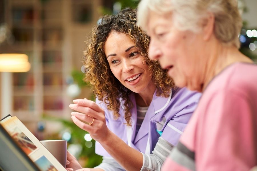 Caregiver giving companionship to a senior woman at home in Los Alamitos, CA