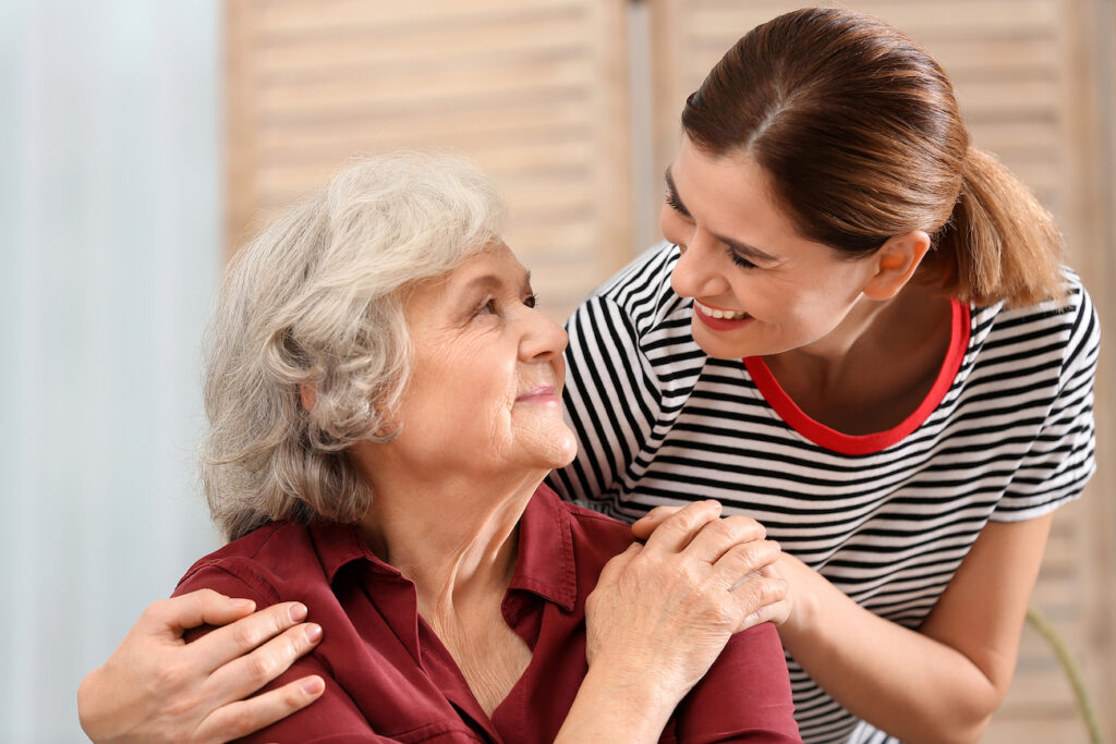 Elderly woman and her caregiver having a deep conversation