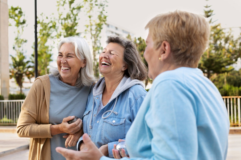 Senior women holding hands and laughing