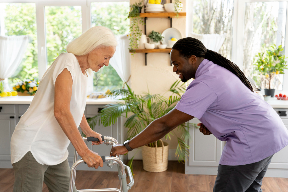 Caregiver helping elderly woman use her walker