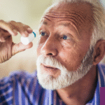 Elderly man using preservative-free artificial tears