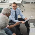 Businessman talking to two elderly people