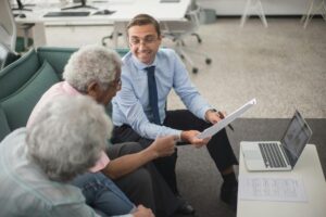 Businessman talking to two elderly people