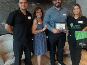 Group of A place at home team standing with award