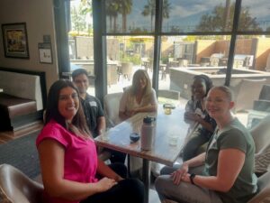 ladies sitting on chair and smile
