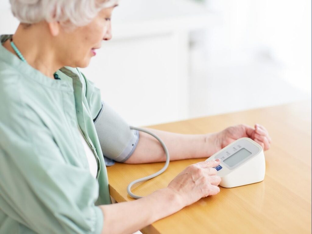 senior checking Blood Pressure