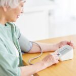 senior checking Blood Pressure